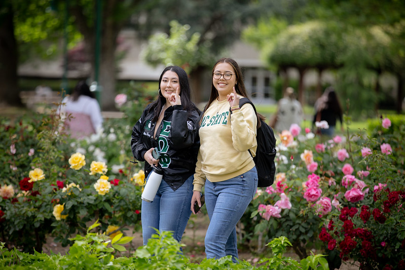 Two students with stingers up hand gesture